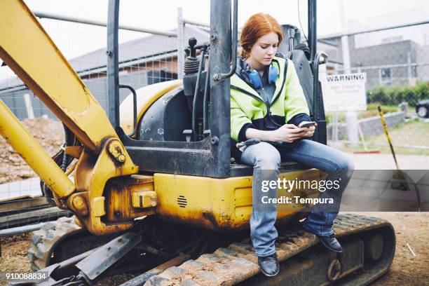 construction workers in australian in building site working and doing tasks. - construction vehicle stock pictures, royalty-free photos & images