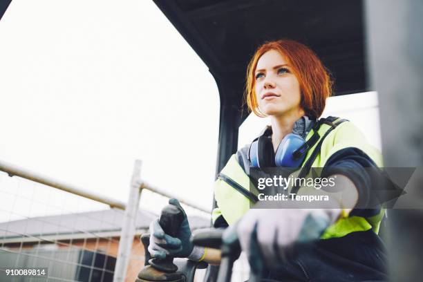 construction workers in australian in building site working and doing tasks. - female builder stock pictures, royalty-free photos & images