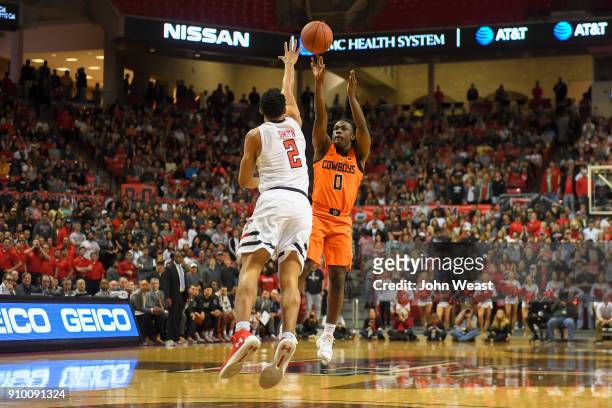 Brandon Averette of the Oklahoma State Cowboys shoots the ball over Zhaire Smith of the Texas Tech Red Raiders during the game on January 23, 2018 at...