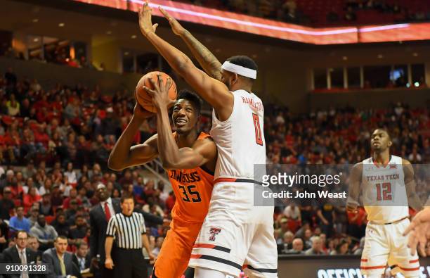 Yankuba Sima of the Oklahoma State Cowboys tries to get around Tommy Hamilton IV of the Texas Tech Red Raiders during the game on January 23, 2018 at...