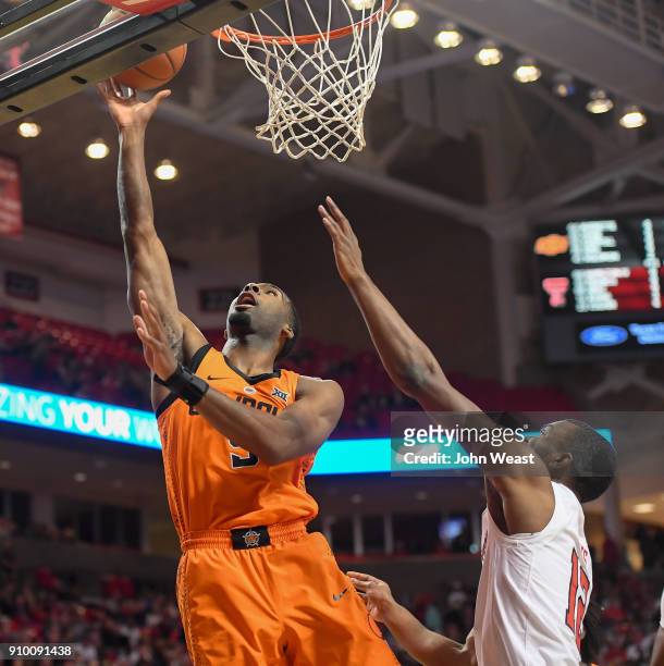 Tavarius Shine of the Oklahoma State Cowboys gets the lay up against Keenan Evans of the Texas Tech Red Raiders during the game on January 23, 2018...