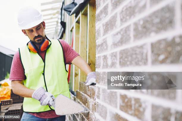construction workers in australian in building site working and doing tasks. - pedreiro imagens e fotografias de stock