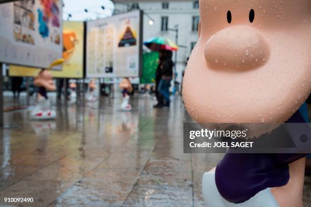 Figure of comic character 'Titeuf' is pictured as visitors look at the exhibition of the Swiss comic series on the occasion of its 25th anniversary...