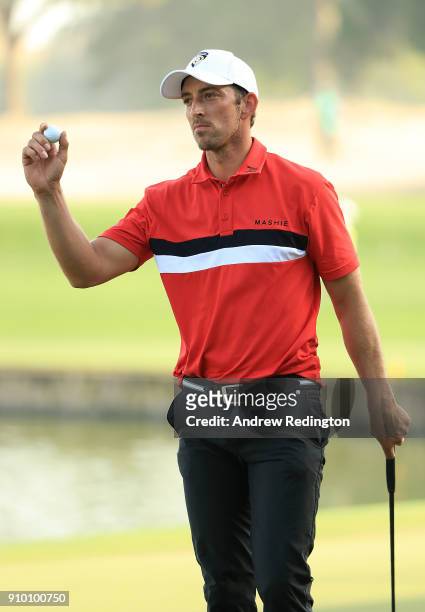 Jamie Elson of England acknowledges the crowd after making burdie on the 9th hole during round one of the Omega Dubai Desert Classic at Emirates Golf...
