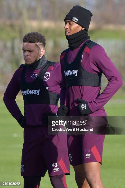 Marcus Browne and Reece Oxford of West Ham United listen to instructions during training at Rush Green on January 25, 2018 in Romford, England.