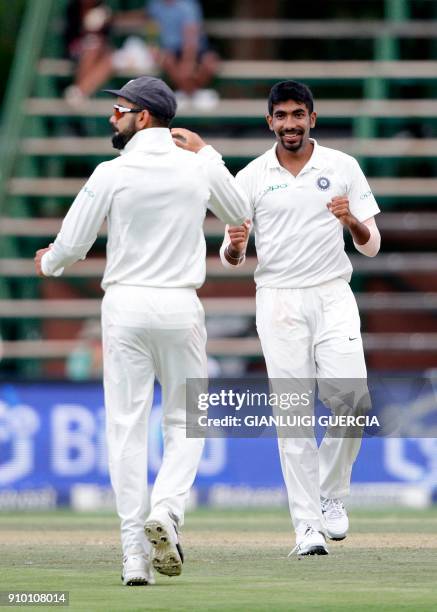 Indian bowler Jasprit Bumrah celebrates the dismissal of South African batsman Hashim Amla during the second day of the third test match between...