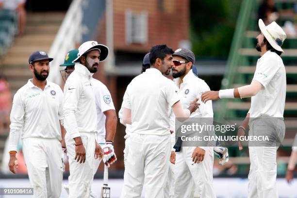 Indian bowler Jasprit Bumrah with teammates celebrates the dismissal of South African batsman Hashim Amla during the second day of the third test...