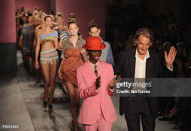 Designer Paul Smith appears on the runway with the models after his fashion show at Claridges Hotel during London Fashion Week on September 21, 2009...