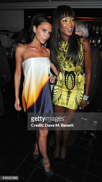 Victoria Beckham and Naomi Campbell attend the private dinner hosted by editor of British Vogue, Alexandra Shulman in association with...