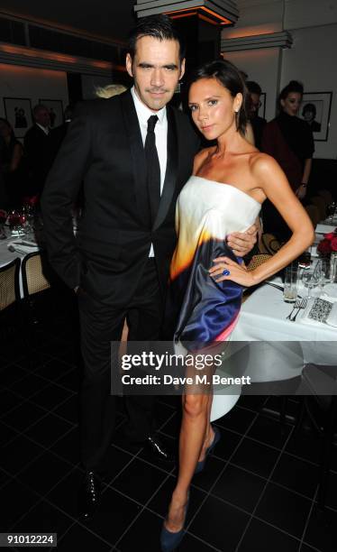 Roland Mouret and Victoria Beckham attend the private dinner hosted by editor of British Vogue, Alexandra Shulman in association with...