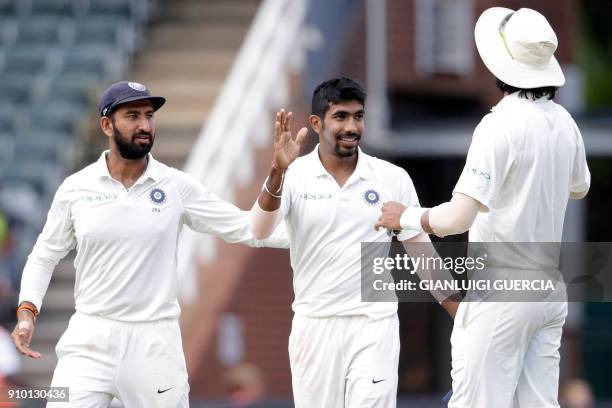 Indian bowler Jasprit Bumrah celebrates the dismissal of South African batsman Lungi Ngidi during the second day of the third test match between...