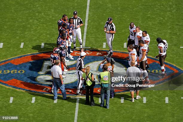 Referee Pete Morelli conducts the coin toss between the Cleveland Browns and the Denver Broncos during NFL action at Invesco Field at Mile High on...