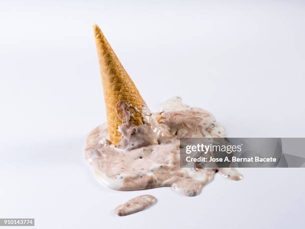 chocolate ice cream in cone that has been spilt in the soil on a white bottom. - milkshake isolated stock pictures, royalty-free photos & images
