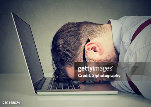 Overworked man lying on laptop Overworked man lying on laptop