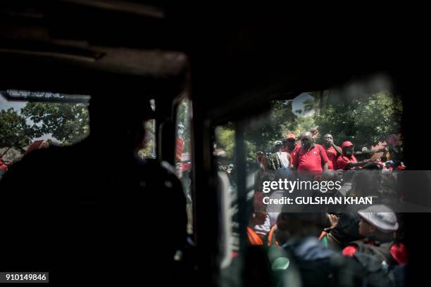 South African Policeman sits inside a Nyala armoured vehicle while members of the South African Teachers Union , African National Congress , Congress...