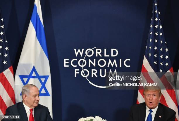 President Donald Trump speaks with Israel's Prime Minister Benjamin Netanyahu during a bilateral meeting on the sidelines of the World Economic Forum...