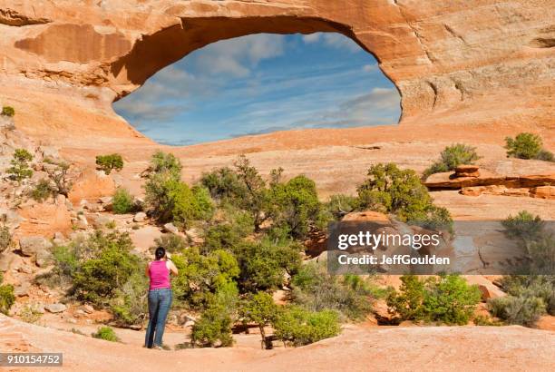 photographing wilson arch - navajo sandstone formations stock pictures, royalty-free photos & images