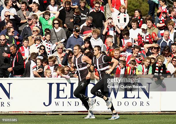 Steven King and Michael Gardiner of the Saints run laps in front of a big crowd during a St Kilda Saints AFL training session at Linen House Oval on...