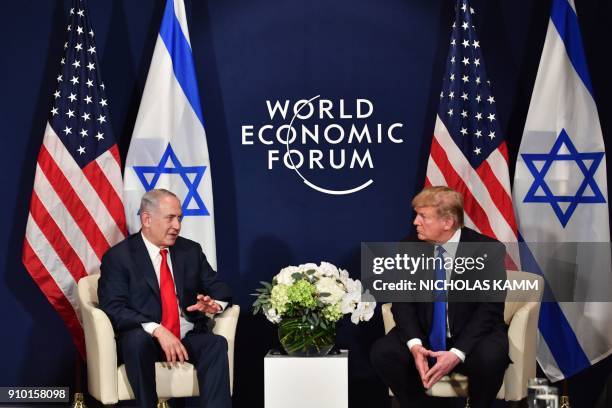 President Donald Trump speaks with Israel's Prime Minister Benjamin Netanyahu during a bilateral meeting on the sidelines of the World Economic Forum...