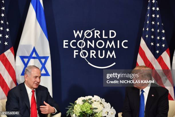 President Donald Trump speaks with Israel's Prime Minister Benjamin Netanyahu during a bilateral meeting on the sidelines of the World Economic Forum...