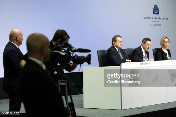Mario Draghi, president of the European Central Bank , second right, speaks as he sits between Christine Graeff, director general for communications...