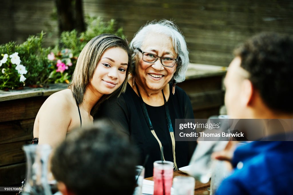 Portrait of smiling grandmother and granddaughter at outdoor family dinner party