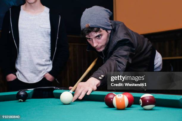 man playing pool billard with friends in a bar - poolbillard billard stock-fotos und bilder