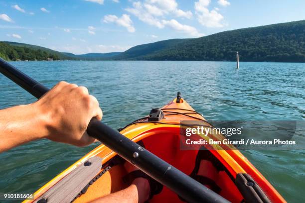 pov of man paddling in kayak on skaneateles lake, skaneateles, new york state, usa - kayaking foto e immagini stock