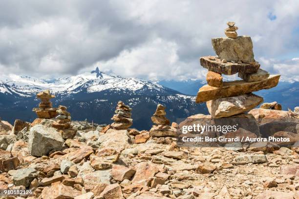 cairns and inukshuks at whistler blackcomb, black tusk mountain visible in background, whistler, british columbia, canada - inukshuk stock pictures, royalty-free photos & images