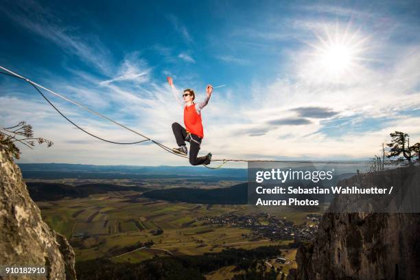 highline athlete walking on slackline in austrian lower alps, peilstein, austria - highlining stock pictures, royalty-free photos & images