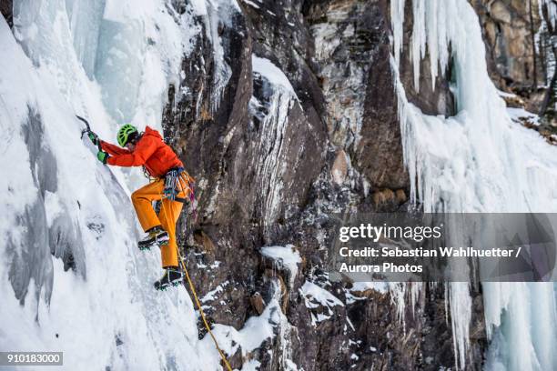 man ice climbing in austrian alps, felbertauern, salzburg, austria - ice pick ストックフォトと画像