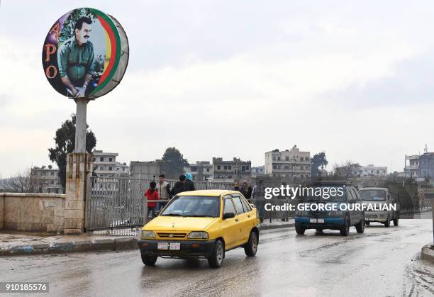 Picture taken on January 25, 2018 shows signs bearing the image of Abdullah Ocalan, leader of the Kurdistan Worker's Party and also known as "Apo",...