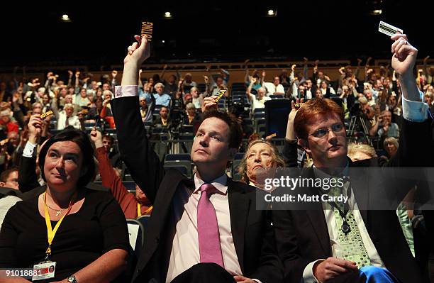 Leader of the party, Nick Clegg and Liberal democrat party members and supporters vote during a policy motion at the Liberal Democrats Party...