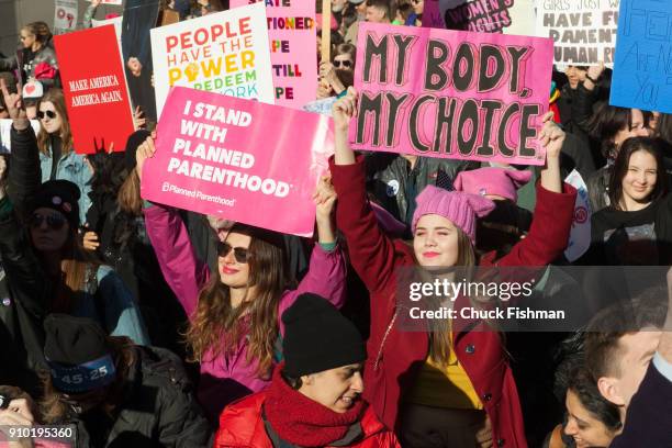 View of demonstrators, many with signs, on Central Park West during the Women's March on New York, New York, New York, January 20, 2018. Among the...