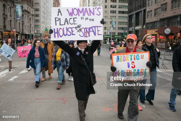 View of a pair of unidentified demonstrators, both with signs, on Sixth Avenue during the Women's March on New York, New York, New York, January 20,...