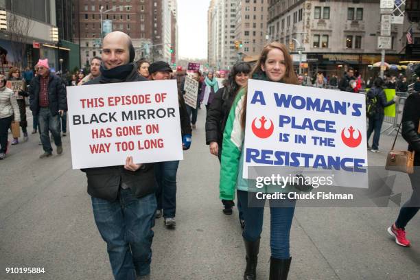 View of a pair of unidentified demonstrators, both with signs, on Sixth Avenue during the Women's March on New York, New York, New York, January 20,...