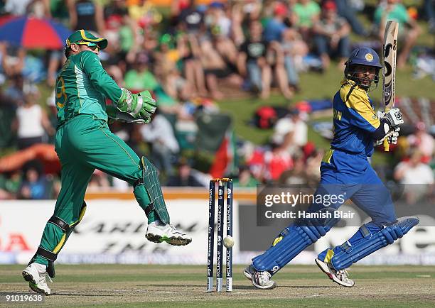 Tillakaratne Dilshan of Sri Lanka cuts with Mark Boucher of South Africa looking on during the ICC Champions Trophy Group B match between South...