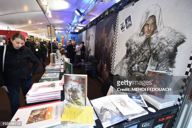 Visitor looks at cartoons displayed during the 45th edition of the Angouleme International Comics Festival in Angouleme, southwestern France, on...