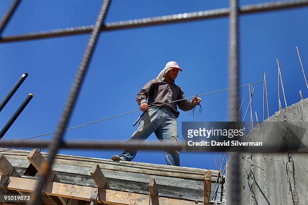 Palestinian laborer works on a new housing project on September 22, 2009 at the Jewish settlement of Maale Adumim in the West Bank. U.S. President...