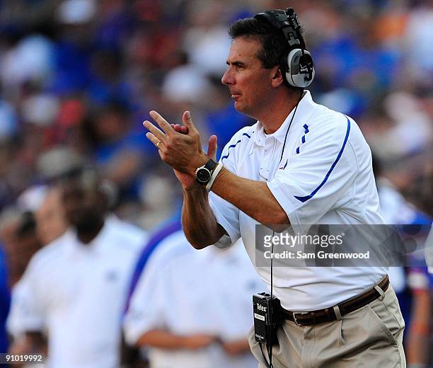 Head coach Urban Meyer of the Florida Gators applauds a touchdown during the game against the Tennessee Volunteers at Ben Hill Griffin Stadium on...