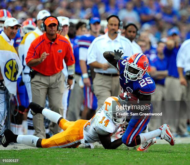 Brandon James of the Florida Gators is tackled by Eric Berry of the Tennessee Volunteers during the game at Ben Hill Griffin Stadium on September 19,...
