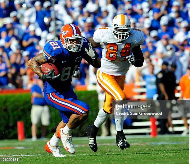 Aaron Hernandez of the Florida Gators is chased by Chris Walker of the Tennessee Volunteers during the game at Ben Hill Griffin Stadium on September...