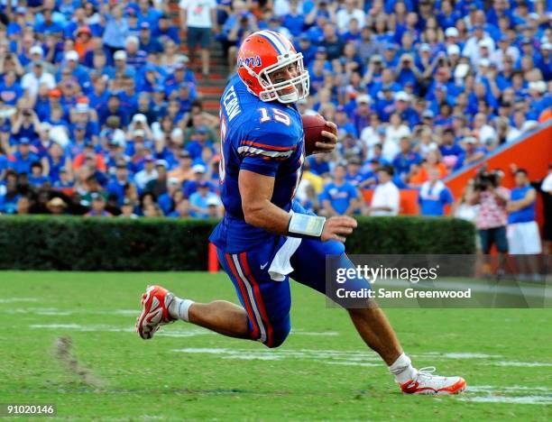 Tim Tebow of the Florida Gators scrambles for yardage during the game against the Tennessee Volunteers at Ben Hill Griffin Stadium on September 19,...