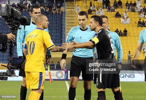 Al-Sadd's Spanish capitan Xavi greets Al-Gharafa's Dutch captain Wesley Sneijder ahead of their Qatar Stars League football match at the Thani bin...