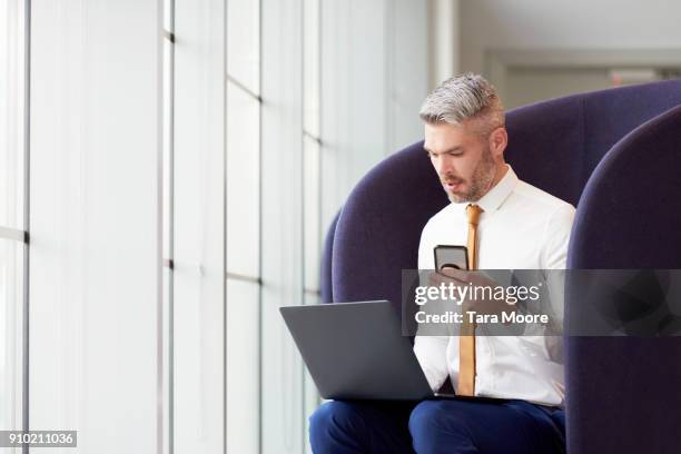 business man with laptop and mobile phone - multitasking concept stock pictures, royalty-free photos & images