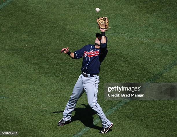 Jamey Carroll of the Cleveland Indians catches a pop up in right field against the Oakland Athletics during the game at the Oakland-Alameda County...