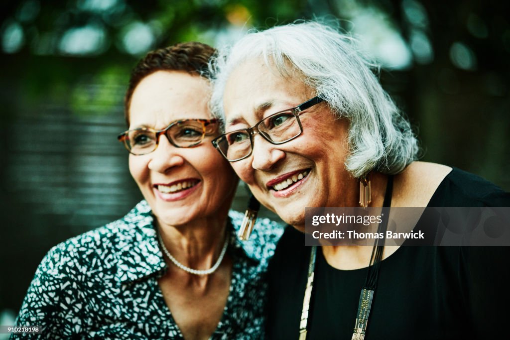 Smiling women posing for picture after family dinner party