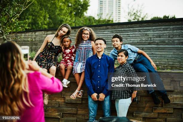 cousins posing for family portrait after dinner party - cousins stock pictures, royalty-free photos & images