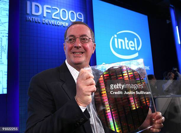 Intel CEO Paul Otellini holds a silicon wafer with a new 22 nanometer SRAM chip after he delivered the keynote address during the 2009 Intel...