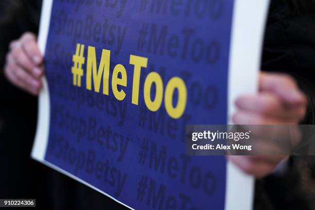 An activist holds a #MeToo sign during a news conference on a Title IX lawsuit outside the Department of Education January 25, 2018 in Washington,...